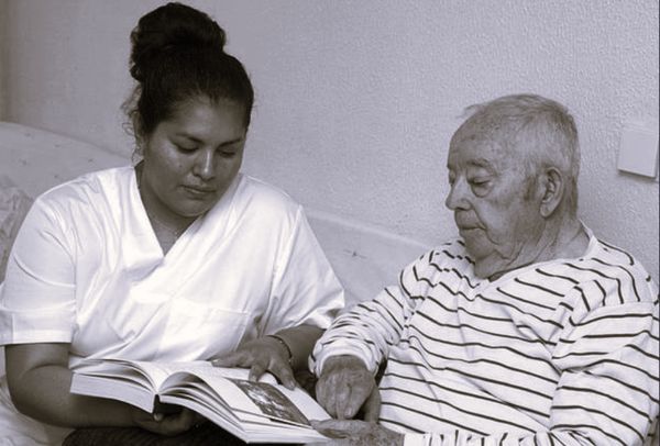 A woman reading with a man.